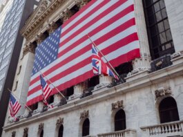 American flag on a historic building exterior symbolizing patriotism and national pride.