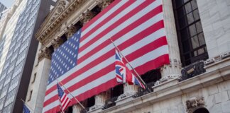 American flag on a historic building exterior symbolizing patriotism and national pride.