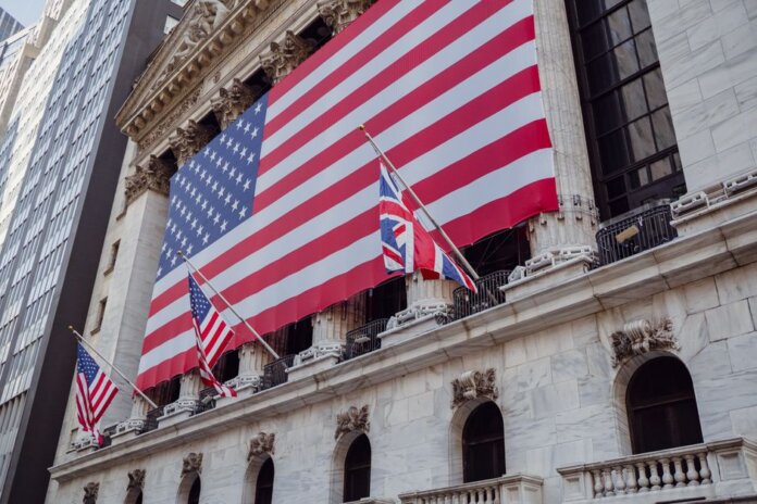 American flag on a historic building exterior symbolizing patriotism and national pride. American flag on a historic building exterior symbolizing patriotism and national pride.