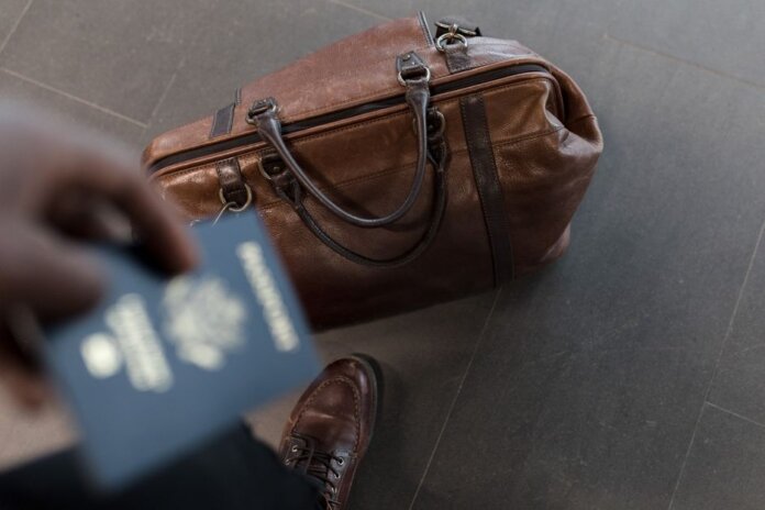 Brown leather bag with passport in an airport setting, ideal for travel and fashion themes. Brown leather bag with passport in an airport setting, ideal for travel and fashion themes.