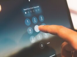 Close-up of a finger entering a passcode on a smartphone security screen.
