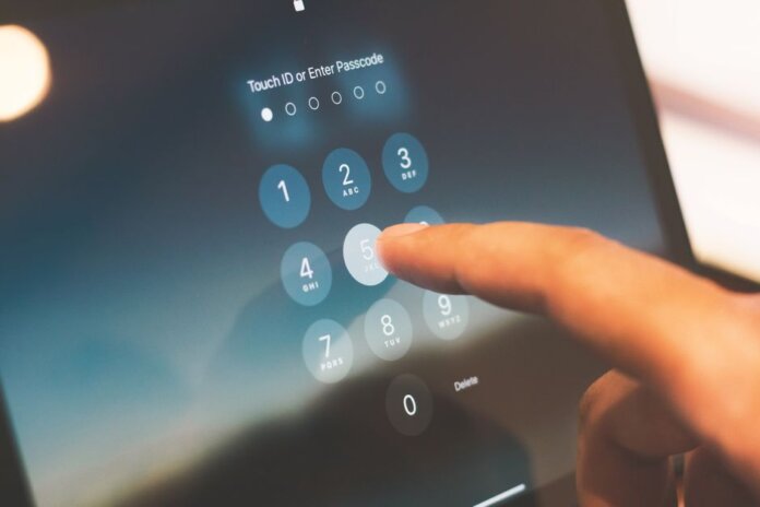 Close-up of a finger entering a passcode on a smartphone security screen. Close-up of a finger entering a passcode on a smartphone security screen.