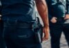 Полиция Онтарио приостанавливает работу с Crime Stoppers после утечки данных Close-up of a police officer's firearm securely holstered at the waist, conveying professionalism and readiness.