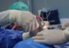 Close-up of surgeons operating in a hospital theater setting with precision.