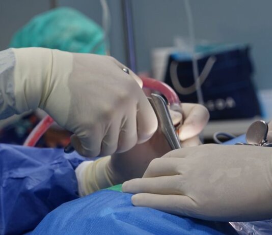 Close-up of surgeons operating in a hospital theater setting with precision.