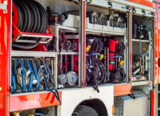 Close-up view of fire truck equipment storage showcasing hoses, tools, and gear.