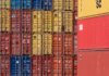 Colorful shipping containers stacked in a port for transport logistics.
