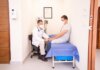 Doctor checking patient's vitals in a clinical setting for health consultation.