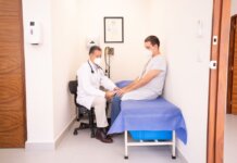 Doctor checking patient's vitals in a clinical setting for health consultation.