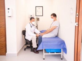 Doctor checking patient's vitals in a clinical setting for health consultation.