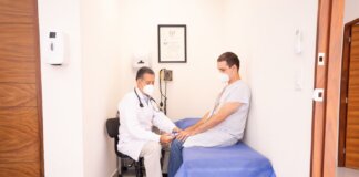 Doctor checking patient's vitals in a clinical setting for health consultation.
