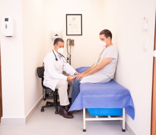Doctor checking patient's vitals in a clinical setting for health consultation.