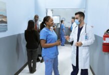 Doctors and nurses in a hospital hallway discussing medical matters.