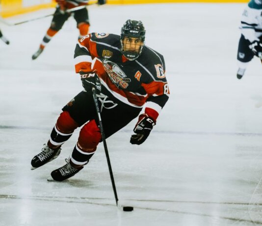Dynamic action shot of a hockey player skating on an ice rink during a game.