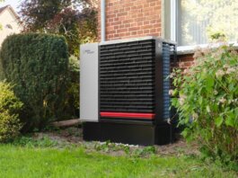 Energy-efficient heat pump in a green residential garden setting.