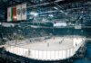 Exciting ice hockey game with players and crowd in a vibrant indoor arena atmosphere.