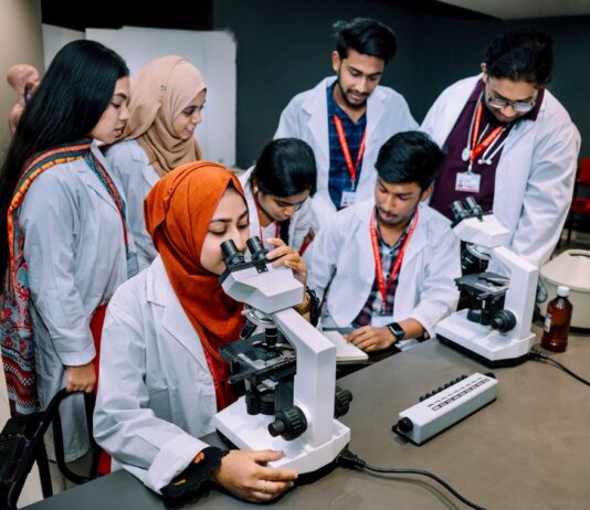 Group of students conducting a lab experiment in a university setting.