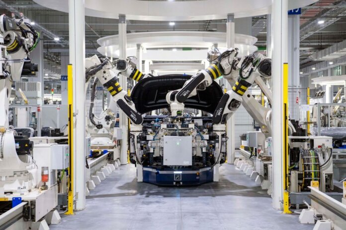 High-tech robots assembling a car in a modern factory setting, showcasing automation. High-tech robots assembling a car in a modern factory setting, showcasing automation.
