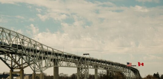 Iconic Blue Water Bridge spanning between the USA and Canada over clear waters.