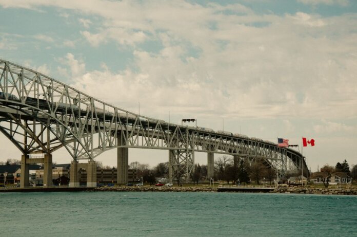 Iconic Blue Water Bridge spanning between the USA and Canada over clear waters. Iconic Blue Water Bridge spanning between the USA and Canada over clear waters.