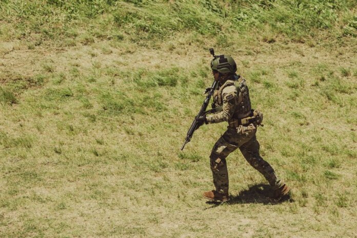 Military soldier in tactical gear running during training exercise at Campo de Mayo, Argentina. Military soldier in tactical gear running during training exercise at Campo de Mayo, Argentina.