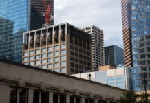 Modern skyscrapers with a construction crane in downtown Calgary, Alberta, Canada.