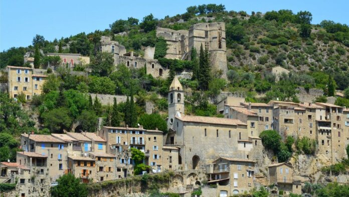 Picturesque historic stone village nestled on a hillside with lush greenery. Picturesque historic stone village nestled on a hillside with lush greenery.