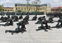Soldiers practice defense tactics outdoors in a coordinated military training exercise.