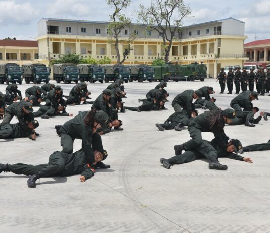 Soldiers practice defense tactics outdoors in a coordinated military training exercise.