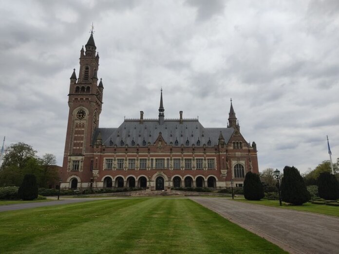 Stunning view of the Peace Palace in The Hague under a cloudy sky. Stunning view of the Peace Palace in The Hague under a cloudy sky.