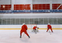«Канадиенс» после поражения от «Каролины» отрабатывали борьбу за шайбу Three hockey players in red uniforms practicing on an indoor ice rink.
