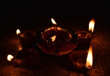 Traditional Diwali diyas casting a warm glow, symbolizing the festival of lights and spiritual warmth.