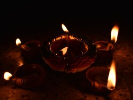Traditional Diwali diyas casting a warm glow, symbolizing the festival of lights and spiritual warmth.