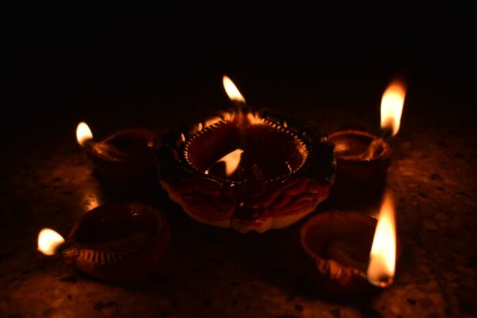 Traditional Diwali diyas casting a warm glow, symbolizing the festival of lights and spiritual warmth. Traditional Diwali diyas casting a warm glow, symbolizing the festival of lights and spiritual warmth.